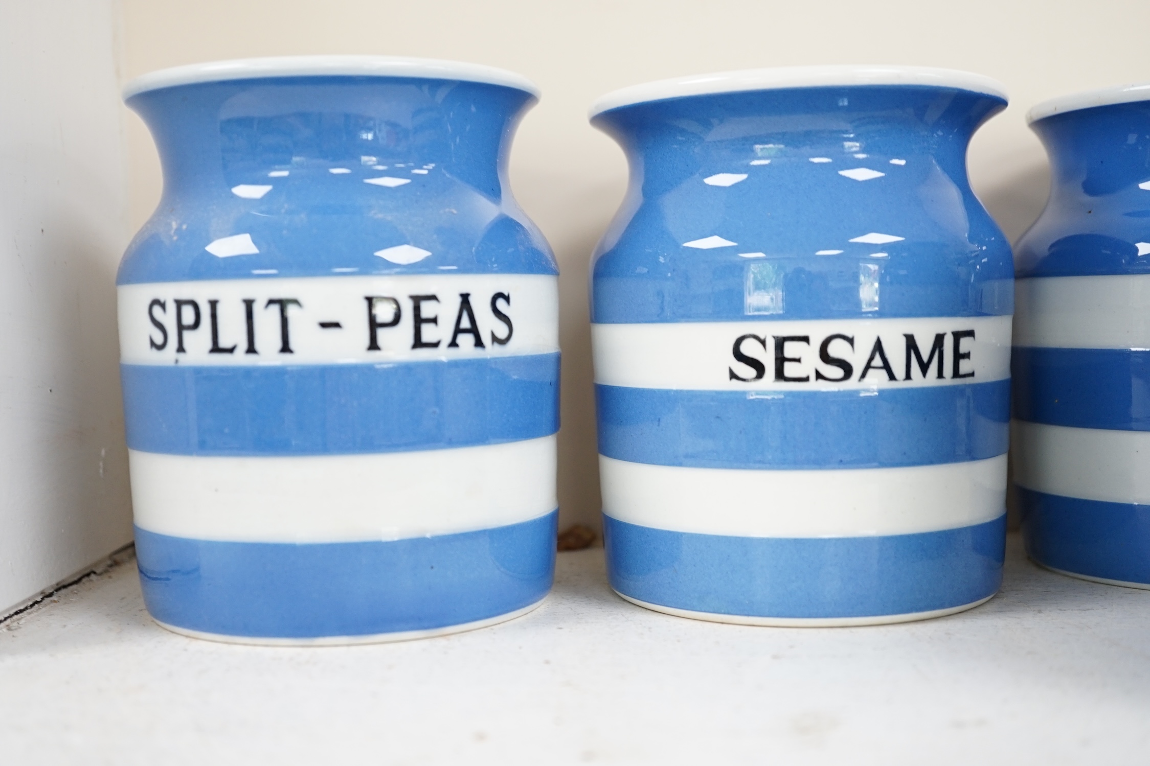 T.G.Green Cornish Kitchenware, ten 12cm and 11cm lidded storage jars to include Pectin, Split Peas, Sesame, Custard Powder and Walnuts, Black Shield marks. Condition - fair to good